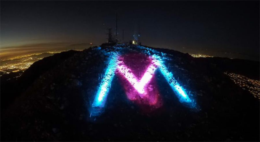 the "M" lit pink and blue